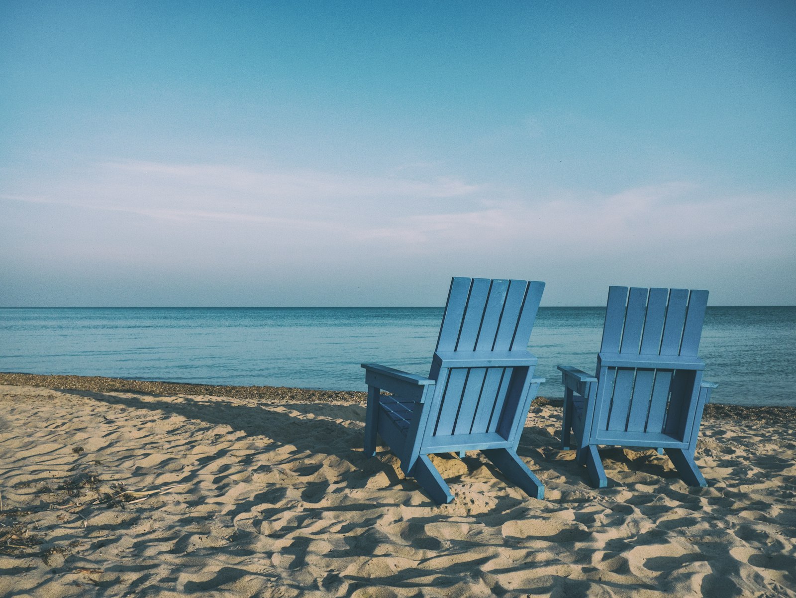 Two deck chairs facing the sea — retirement saving with a workplace pension